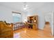 Bright living room with hardwood floors, large window, and a cozy plaid sofa at 8869 Sw 194Th Ct, Dunnellon, FL 34432