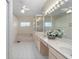 Neutral-toned main bathroom offers a soaking tub, a walk-in shower, and a double vanity at 8869 Sw 194Th Ct, Dunnellon, FL 34432