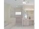 A neutral-toned main bathroom offers a soaking tub, walk-in shower, and vanity at 8869 Sw 194Th Ct, Dunnellon, FL 34432