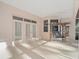 Relaxing covered patio with swing, ceiling fan, and doors to the house at 8869 Sw 194Th Ct, Dunnellon, FL 34432