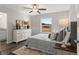 Bright bedroom boasts a large window, ceiling fan, and comfortable decor at 10 Sequoia Trail Ter, Ocklawaha, FL 32179