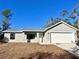 Charming single-story home featuring a new metal roof, attached garage, and neatly staged front yard at 10 Sequoia Trail Ter, Ocklawaha, FL 32179
