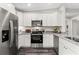 Well-equipped kitchen boasting white cabinets, stainless steel appliances, and granite countertops at 10 Sequoia Trail Ter, Ocklawaha, FL 32179