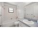 Functional bathroom features a shower-tub combo, a mirrored medicine cabinet, and a single sink vanity at 10690 Se 44Th Ter, Belleview, FL 34420