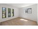 Bedroom with hardwood floors and large windows offering bright natural light at 10690 Se 44Th Ter, Belleview, FL 34420