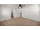 Bedroom featuring hardwood floors, ceiling fan, and access to closets at 10690 Se 44Th Ter, Belleview, FL 34420