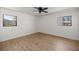 This bedroom has hardwood floors and a ceiling fan and has nice natural light at 10690 Se 44Th Ter, Belleview, FL 34420
