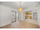 Open dining room with wood floors next to a bright kitchen and sliding doors at 10690 Se 44Th Ter, Belleview, FL 34420
