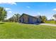 Stylish home with stone accents, a side-entry garage, and a green lawn at 10690 Se 44Th Ter, Belleview, FL 34420