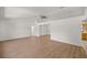 Open-concept living room with hardwood floors, ceiling fan, and natural light at 10690 Se 44Th Ter, Belleview, FL 34420