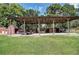 Large open-air barn with a small storage shed and trailer at 10750 Nw 7Th St, Ocala, FL 34482