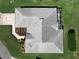 Aerial view of home showcasing the roof, screened patio, and manicured landscaping at 11010 Se 174Th Loop, Summerfield, FL 34491