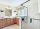 Modern bathroom features a spacious vanity, ample countertop space, and a sleek glass-enclosed shower at 11010 Se 174Th Loop, Summerfield, FL 34491