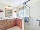 Bright bathroom features a vanity with countertop space, a glass-enclosed shower, and stylish fish decor at 11010 Se 174Th Loop, Summerfield, FL 34491