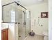 Modern bathroom features a sleek glass shower enclosure, elegant fixtures, and stylish decor at 11010 Se 174Th Loop, Summerfield, FL 34491