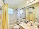 Clean bathroom with bathtub-shower combo, vanity, and white tile, providing a functional space at 11010 Se 174Th Loop, Summerfield, FL 34491