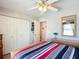 Well-lit bedroom with ample closet space, ceiling fan, and neutral decor, perfect for relaxation at 11010 Se 174Th Loop, Summerfield, FL 34491