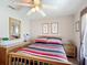 Inviting bedroom with natural light, ceiling fan, and tasteful decor creating a peaceful retreat at 11010 Se 174Th Loop, Summerfield, FL 34491