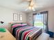 Comfortable bedroom featuring a ceiling fan, natural light, and tasteful decor creating a relaxing space at 11010 Se 174Th Loop, Summerfield, FL 34491