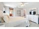 Spacious bedroom offers a comfortable bed, ample storage with a dresser, and access to other rooms at 11010 Se 174Th Loop, Summerfield, FL 34491