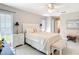 Well-lit bedroom features a cozy bed, coordinating nightstands, and a view of the outdoors at 11010 Se 174Th Loop, Summerfield, FL 34491