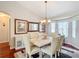 Elegant dining room featuring a large table with seating for six, complemented by stylish decor and ample natural light at 11010 Se 174Th Loop, Summerfield, FL 34491