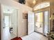 Inviting foyer with tile flooring, arch window, and front door, offering a glimpse into the home's interior at 11010 Se 174Th Loop, Summerfield, FL 34491