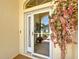 Charming front door with decorative floral arrangement and tiled entryway, adding curb appeal to the home at 11010 Se 174Th Loop, Summerfield, FL 34491