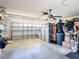 Spacious garage with ample storage space and organized shelving, providing convenient parking and storage solutions at 11010 Se 174Th Loop, Summerfield, FL 34491