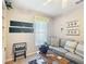 Cozy living room features comfortable seating, stylish decor, and ample natural light through the window at 11010 Se 174Th Loop, Summerfield, FL 34491