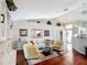 Comfortable living room with hardwood floors, vaulted ceilings, and stylish furnishings at 11010 Se 174Th Loop, Summerfield, FL 34491