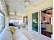 Bright sunroom features tile flooring, ceiling fans, and comfortable seating, perfect for relaxing or entertaining guests at 11010 Se 174Th Loop, Summerfield, FL 34491