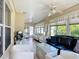 Well-lit sunroom showcases comfortable furnishings and scenic views, creating a cozy space for relaxation and gatherings at 11010 Se 174Th Loop, Summerfield, FL 34491