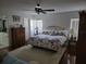 Spacious bedroom featuring natural lighting, wood floors, and large bed at 11395 Sw 139Th St, Dunnellon, FL 34432