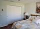 Cozy bedroom features a closet, bedside lamp, and bed with a patterned quilt at 11395 Sw 139Th St, Dunnellon, FL 34432
