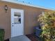 Exterior view of a side entrance, with a security light, and landscaping detail at 11395 Sw 139Th St, Dunnellon, FL 34432