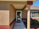Covered front entrance with a screen door, decorative column, and manicured bushes at 11395 Sw 139Th St, Dunnellon, FL 34432
