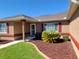 Charming single-story home boasts colorful landscaping, stucco exterior, and bright red shutters and trim at 11395 Sw 139Th St, Dunnellon, FL 34432