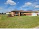 Charming single-story home with well-manicured lawn and garden beds with brown mulch at 11395 Sw 139Th St, Dunnellon, FL 34432