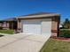 Attached one-car garage featuring a concrete driveway and well-maintained landscaping at 11395 Sw 139Th St, Dunnellon, FL 34432