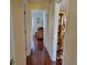 Hallway featuring a wood floor and doors leading to other rooms at 11395 Sw 139Th St, Dunnellon, FL 34432