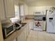 Well-lit kitchen features white appliances, ample cabinet space, and light-colored countertops at 11395 Sw 139Th St, Dunnellon, FL 34432