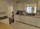 Bright kitchen boasts white cabinets, stainless steel appliances, and a window over the sink at 11395 Sw 139Th St, Dunnellon, FL 34432