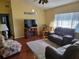 Inviting living room featuring a plush rug, comfortable seating, and natural light from large windows at 11395 Sw 139Th St, Dunnellon, FL 34432