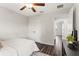Bright bedroom featuring ceiling fan, wood floors, and a spacious closet at 12 Fisher Loop Ct, Ocklawaha, FL 32179