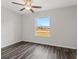 Empty bedroom with wood floor and window views at 12 Fisher Loop Ct, Ocklawaha, FL 32179