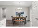 A modern dining room features a wooden table, stylish black chairs, and a chandelier at 12 Fisher Loop Ct, Ocklawaha, FL 32179