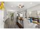 Bright, open-concept living room with hardwood floors, stylish furnishings, and ample natural light at 12 Fisher Loop Ct, Ocklawaha, FL 32179