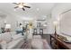 Spacious living room showcasing hardwood floors, an open floor plan, and seamless connection to the kitchen and dining area at 12 Fisher Loop Ct, Ocklawaha, FL 32179