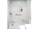Accessible walk-in shower with seating, grab bar, and tiled niche for toiletries at 13780 Sw 111Th Ave, Dunnellon, FL 34432
